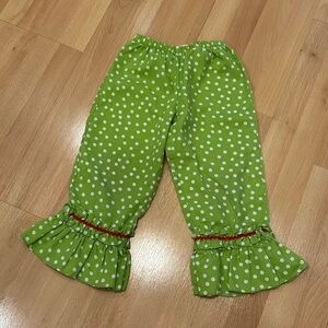 Green and white polka dot pants with ruffle detail